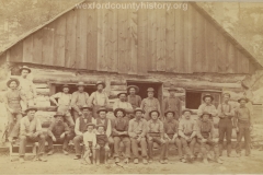 Cadillac-Lumber-Lumberjacks-Posing-In-Front-Of-Camp-Building-1