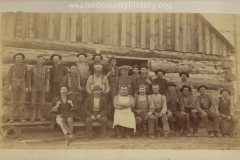 Cadillac-Lumber-Lumberjacks-Posing-In-Front-Of-Camp-Building