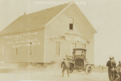 Cadillac-Business-Acme-Truck-Moving-A-House-1