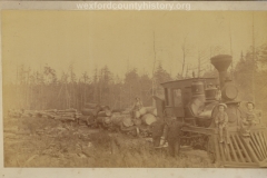 Cadillac-Lumber-Engine-Pulling-Nine-Cars-Of-Logs-With-Children-Posed-On-Cow-Catcher